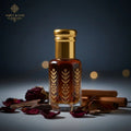 Mukhalath Burj amber attar bottle with clean gold cap in a dark-blue setting