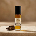 Royal Oud Body Oil bottle with a compact cream-and-gold label and golden oil visible above and below