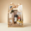 A&O signature five-item gift set on an ivory tabletop with a champagne studio background
